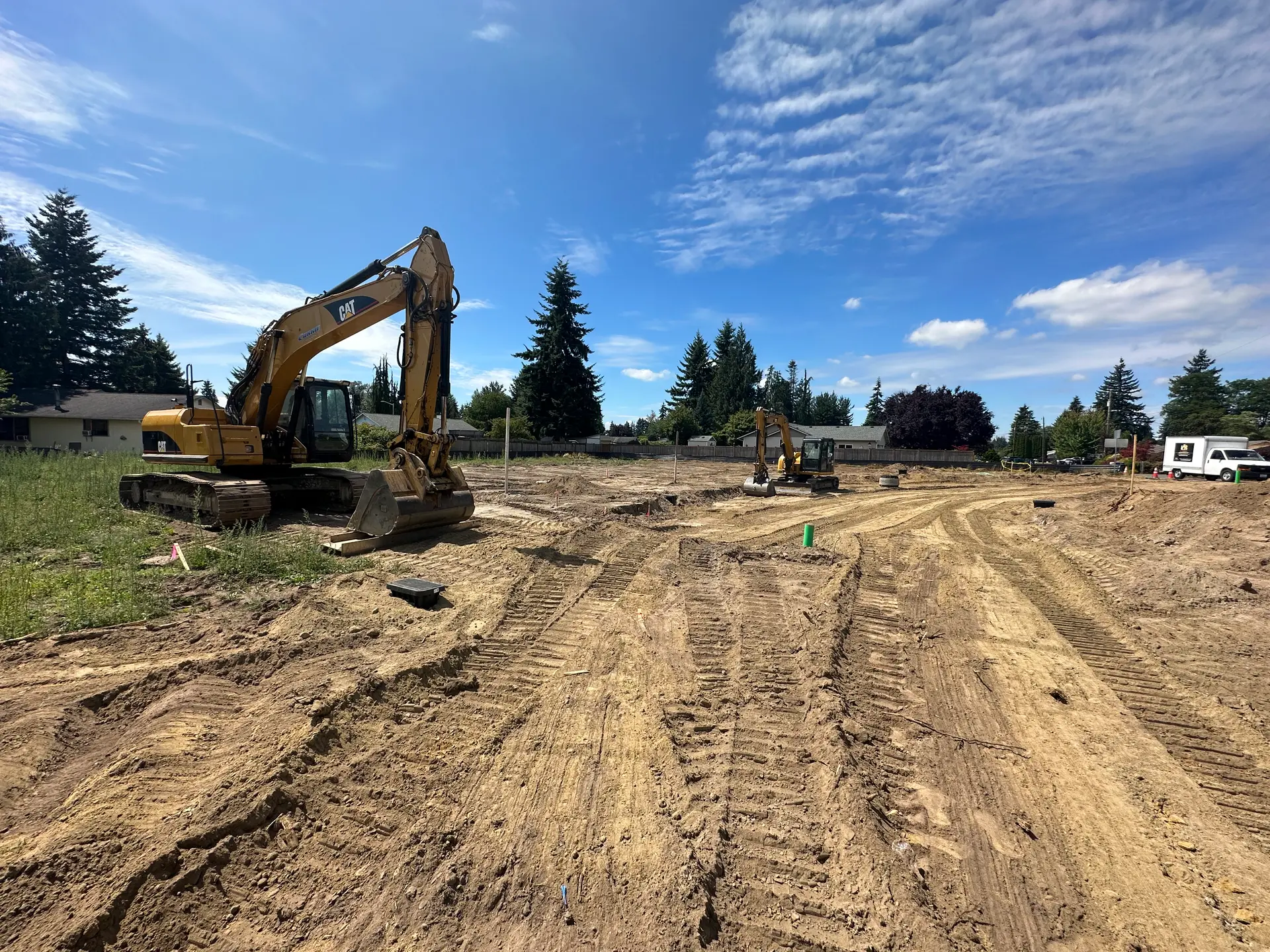 O's Sons Construction grading a residential development site with an excavator in Snohomish County WA